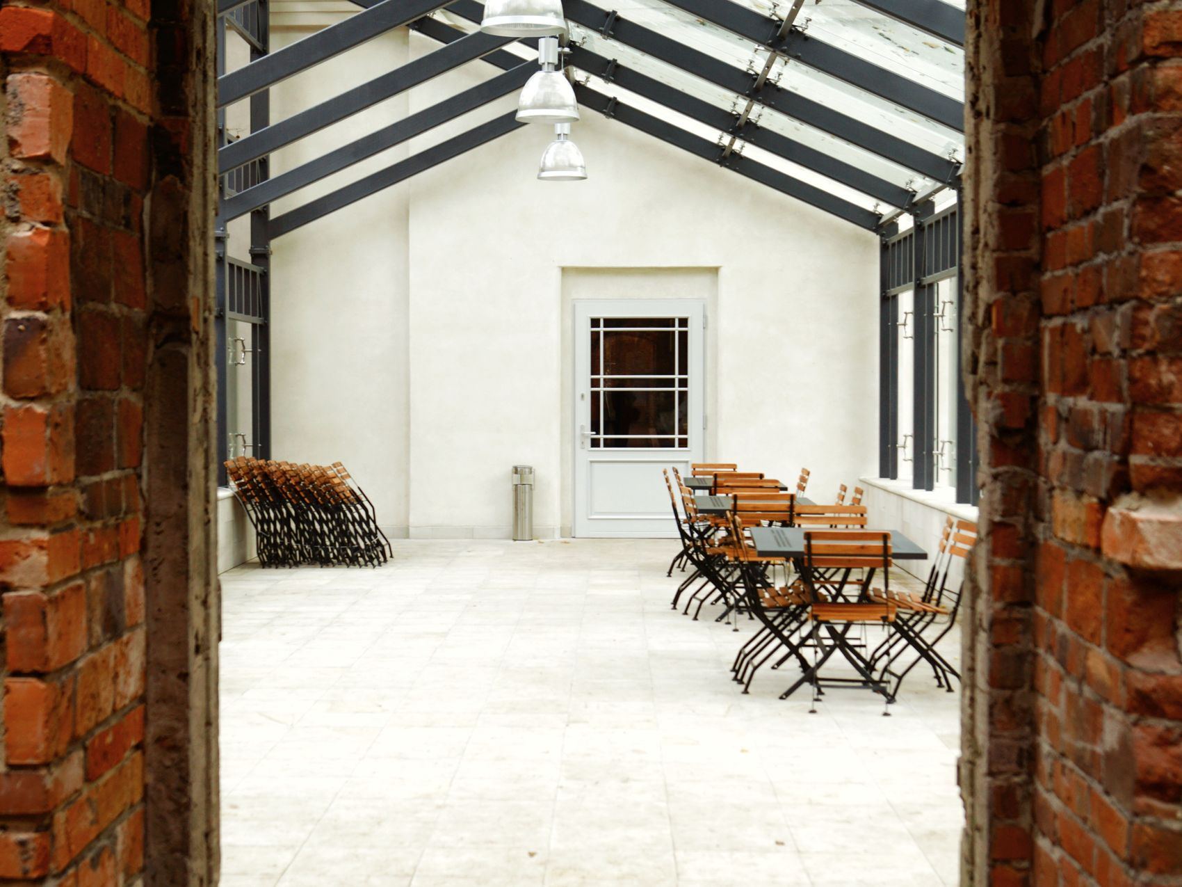 Indoor dining area with wooden tables and exposed brick walls.